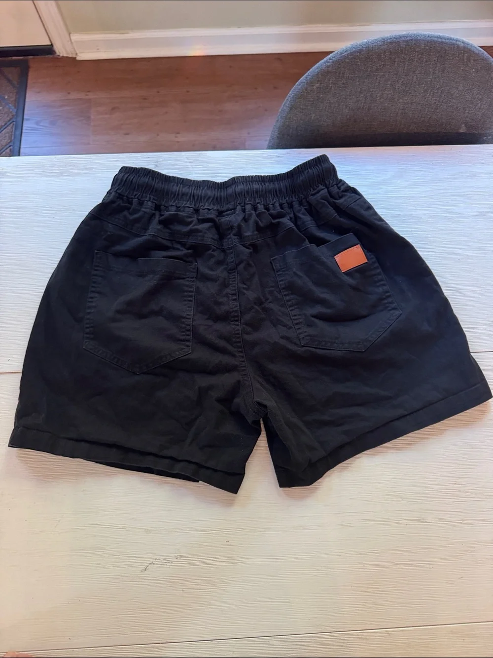 Amazon Men's Black Athletic Shorts with Orange Patch